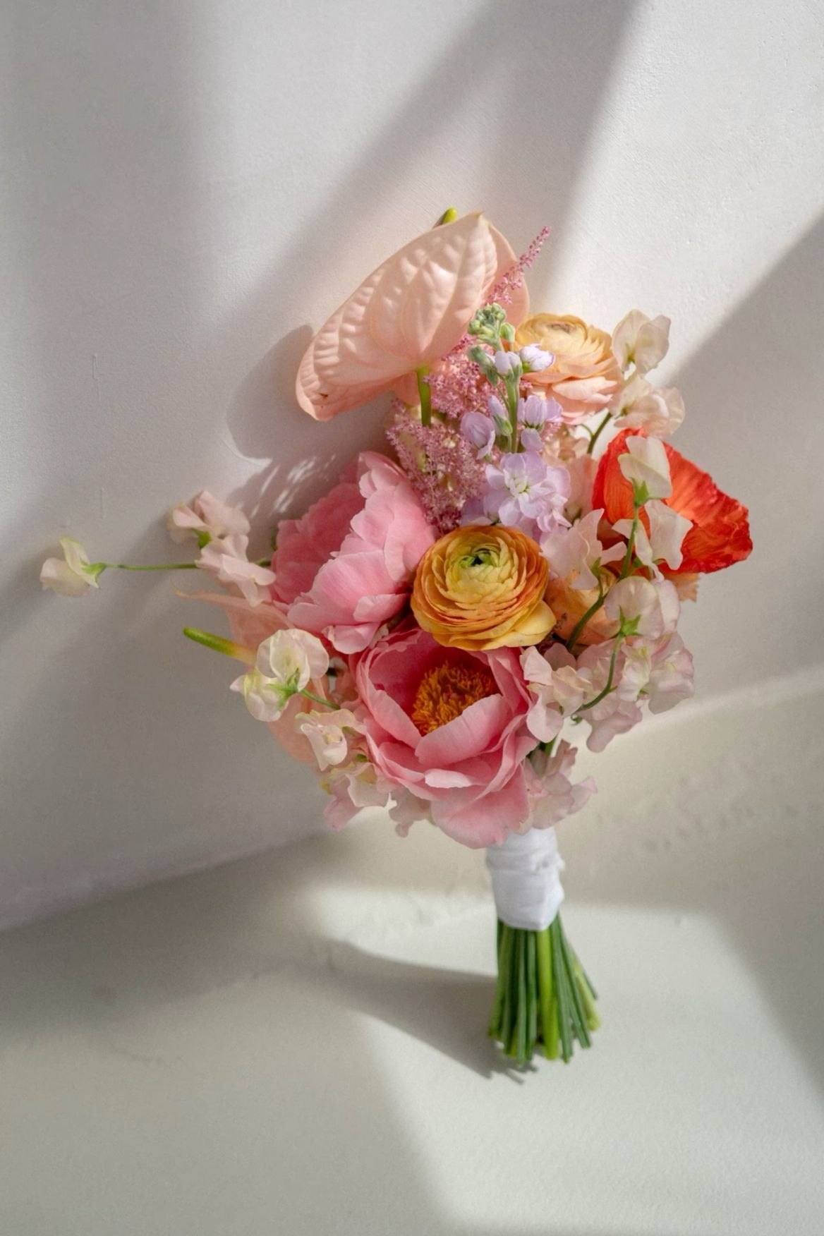 Soft pink, peach, lavender, and cream wedding bouquet